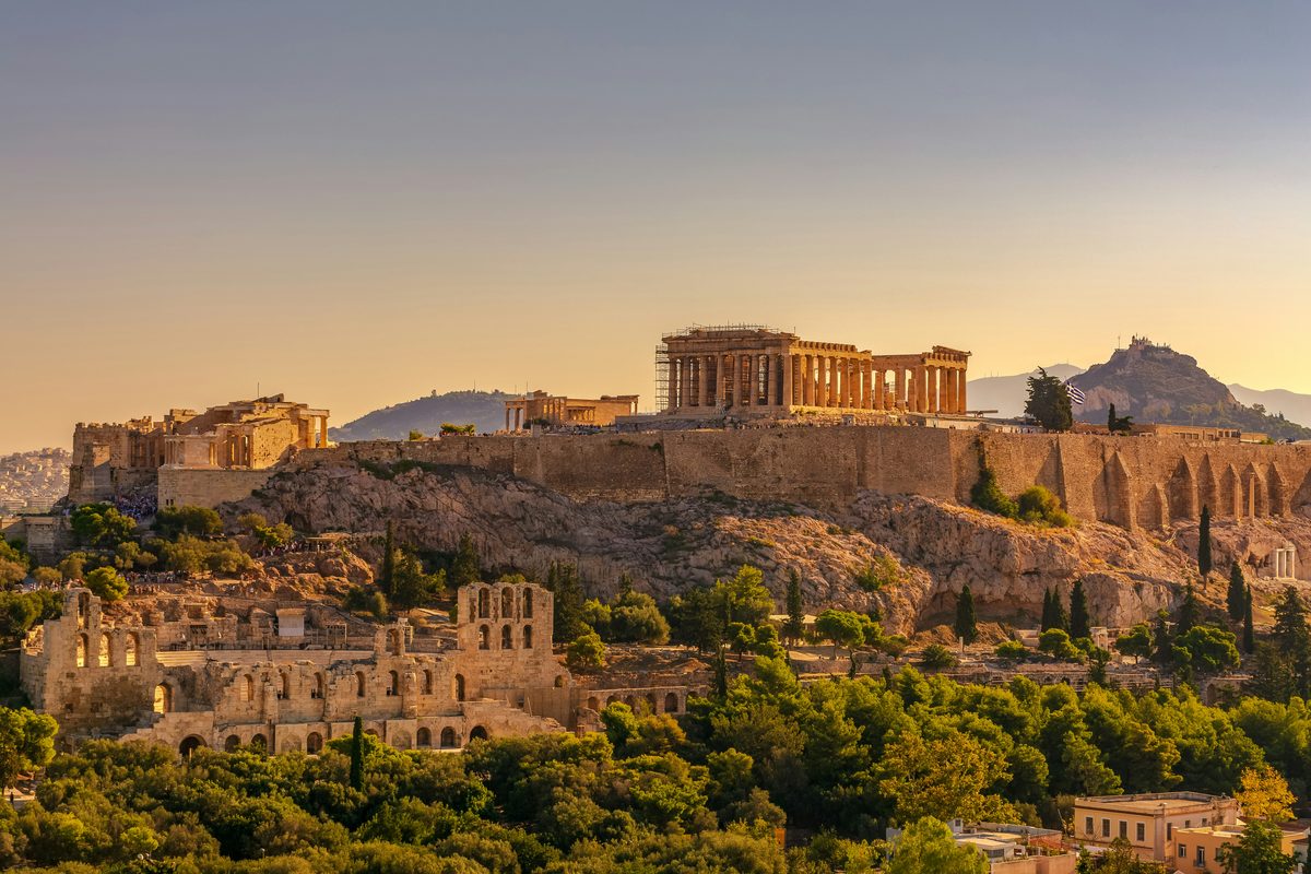 The Acropolis of Athens crowned by the Parthenon in warm evening light
