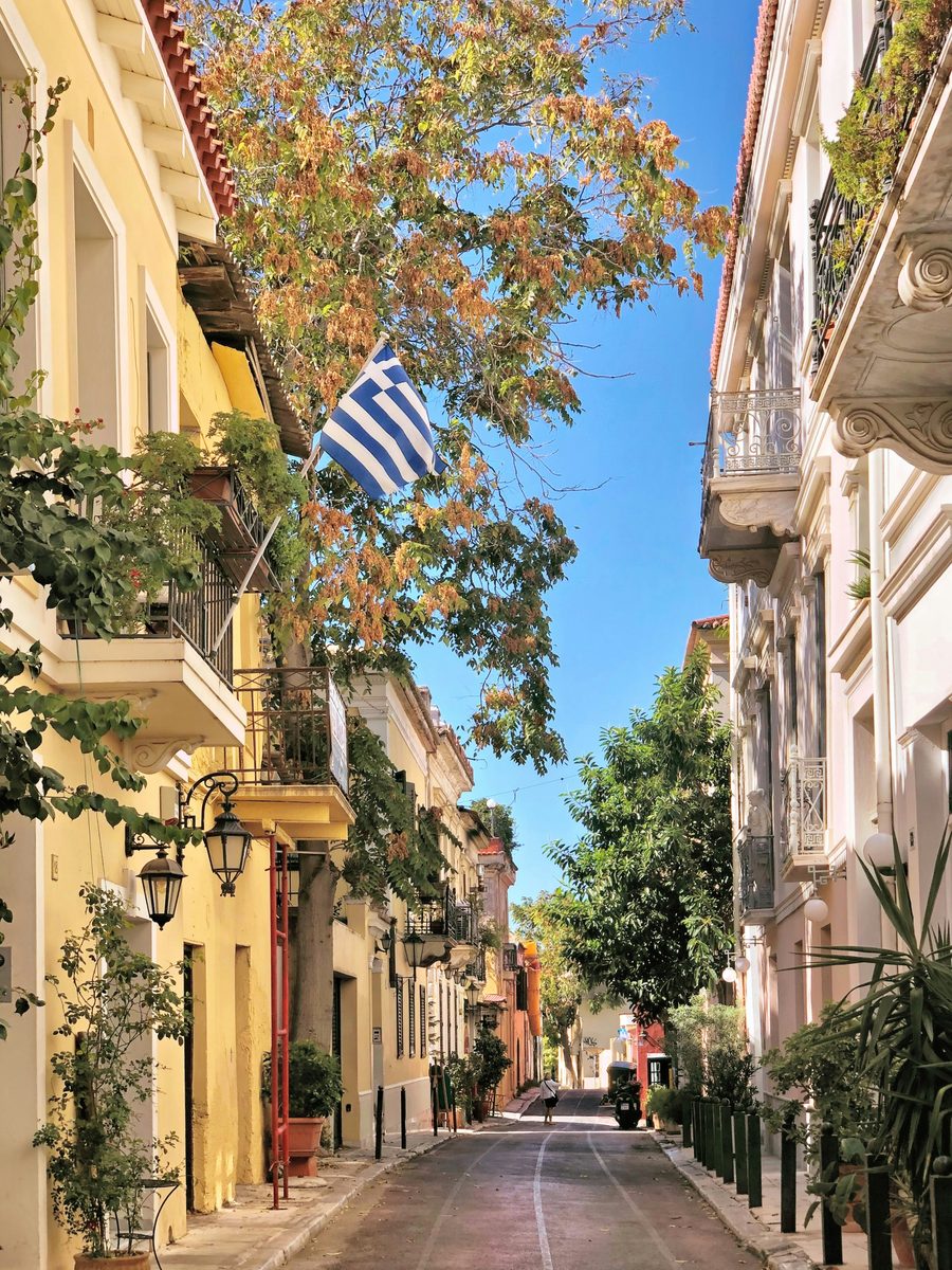A street of neoclassical houses with a Greek flag in the Plaka district of Athens